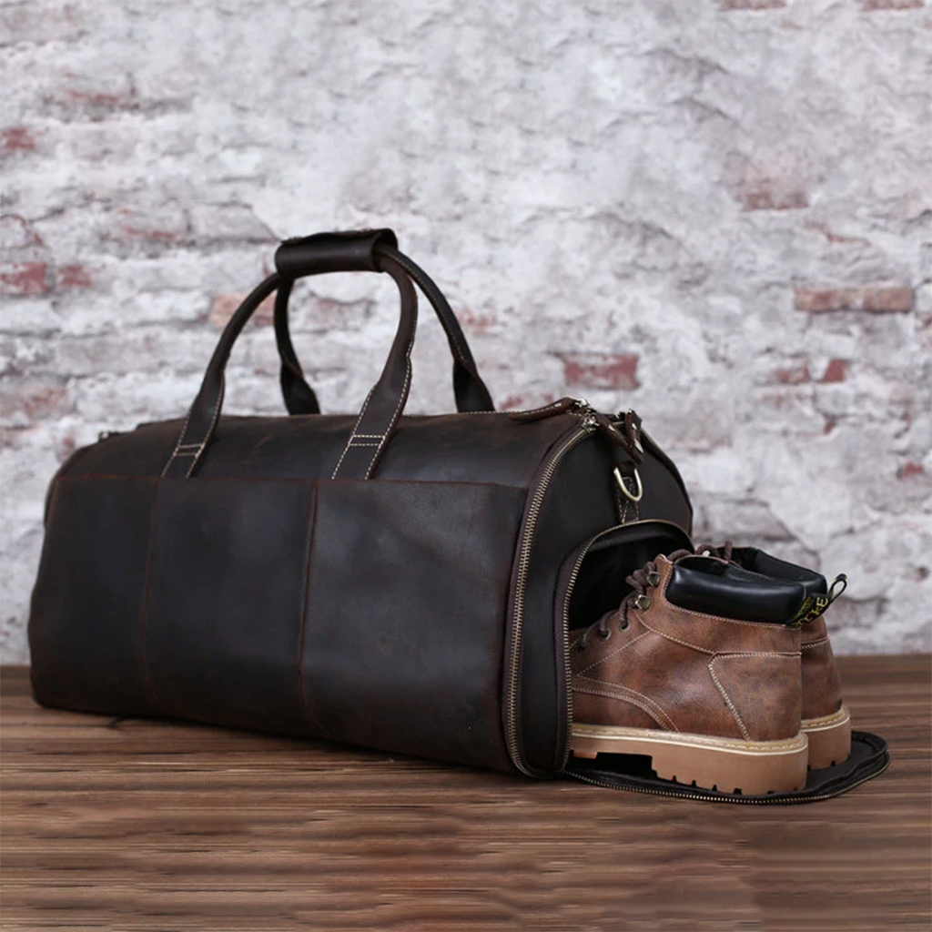 Full-grain brown leather garment duffel bag with carry handles
